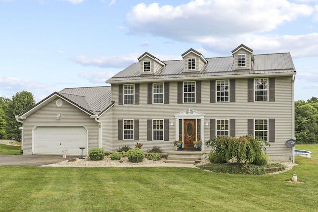 colonial-style house with a front yard and a garage