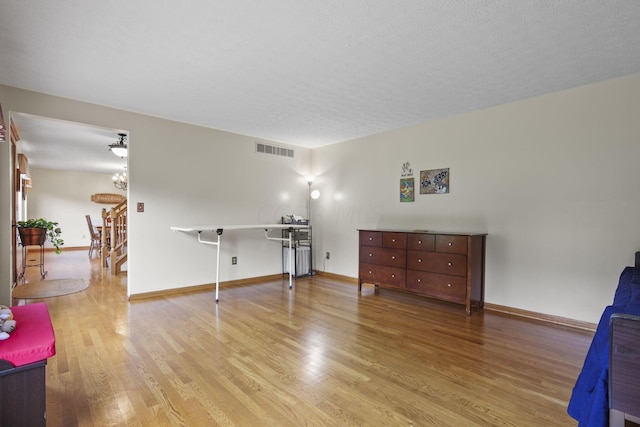 living room with hardwood / wood-style floors and a textured ceiling