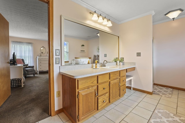 bathroom with tile patterned floors, vanity, ornamental molding, and a textured ceiling