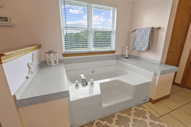 bathroom featuring tile patterned flooring and a washtub