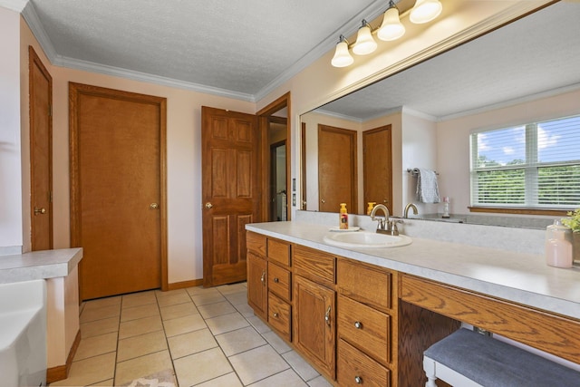 bathroom with tile patterned flooring, vanity, a textured ceiling, and crown molding