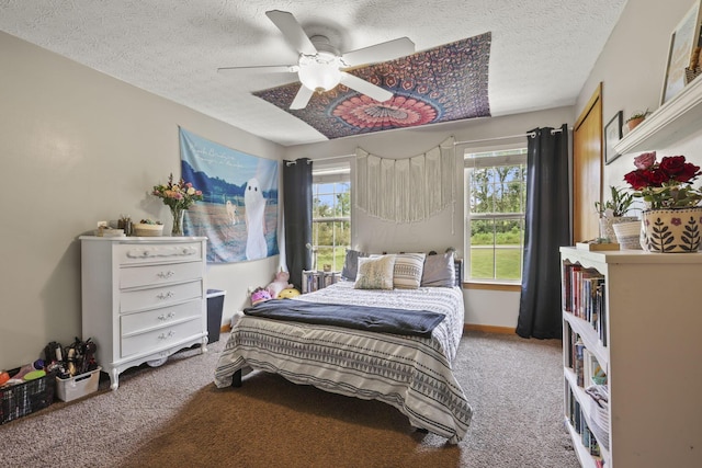 bedroom with ceiling fan, carpet floors, a textured ceiling, and multiple windows