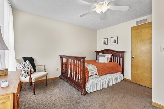 carpeted bedroom with ceiling fan and a textured ceiling