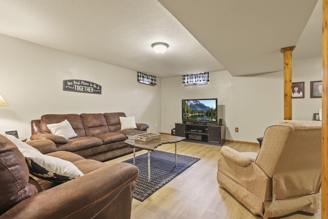 living room featuring light hardwood / wood-style floors and a textured ceiling