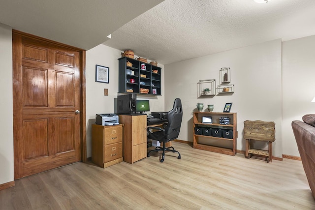 office space with a textured ceiling and light wood-type flooring