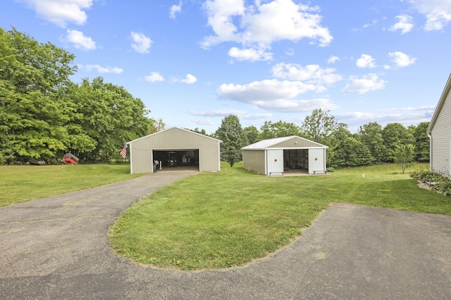 view of outdoor structure with a lawn and a garage