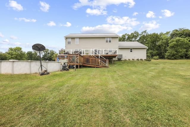 back of house with a lawn and a deck