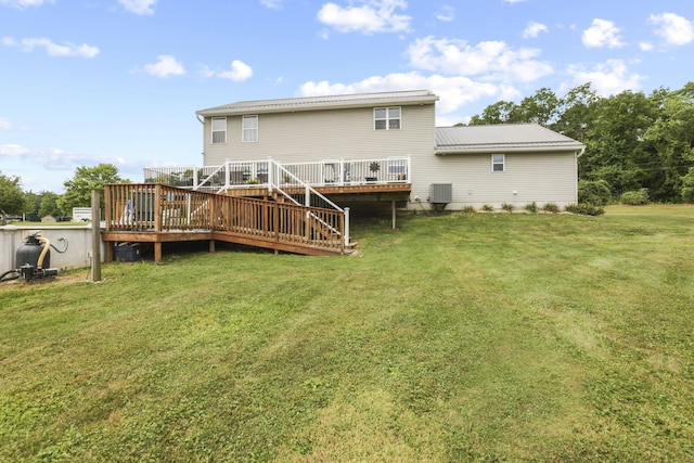 rear view of property with a yard and a deck