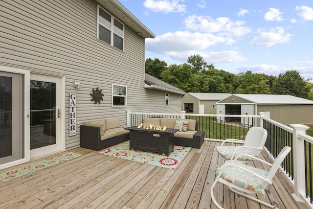 wooden deck with an outdoor living space with a fire pit