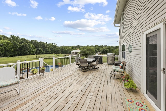 wooden terrace with area for grilling and a yard