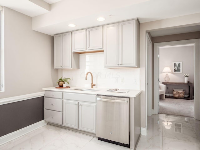 50 W Broad St Unit 2905, Columbus, OH 43215 - kitchen featuring stainless steel dishwasher, light marble finish flooring, recessed lighting, light countertops, and backsplash