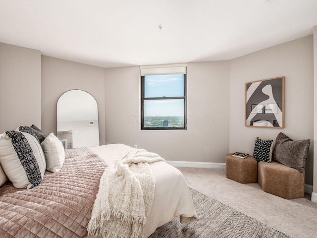 50 W Broad St Unit 2905, Columbus, OH 43215 - carpeted bedroom featuring baseboards and arched walkways
