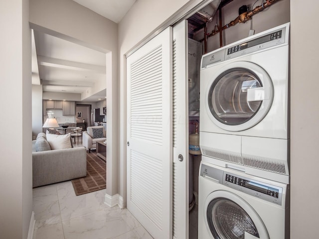 50 W Broad St Unit 2905, Columbus, OH 43215 - laundry room with stacked washer and clothes dryer and light marble finish flooring