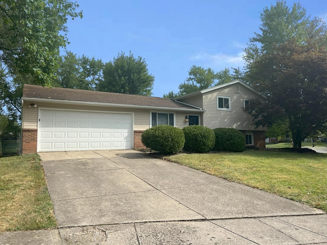 tri-level home featuring a front yard and a garage