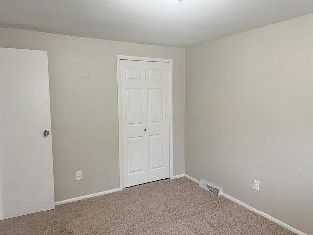 unfurnished bedroom with carpet floors and a closet