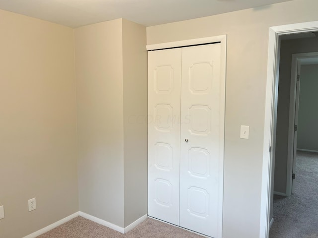 unfurnished bedroom with carpet flooring and a closet