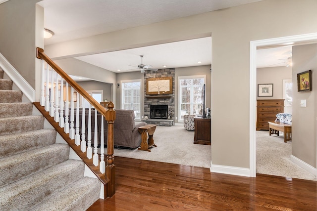 interior space featuring hardwood / wood-style floors, a fireplace, and ceiling fan