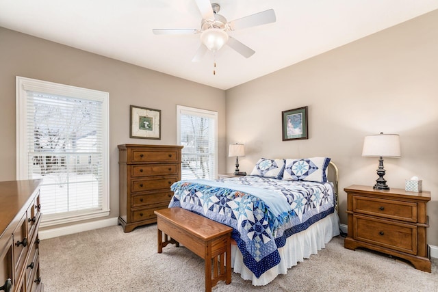 bedroom with ceiling fan and light colored carpet