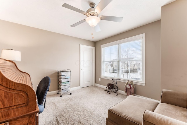 carpeted office space featuring ceiling fan