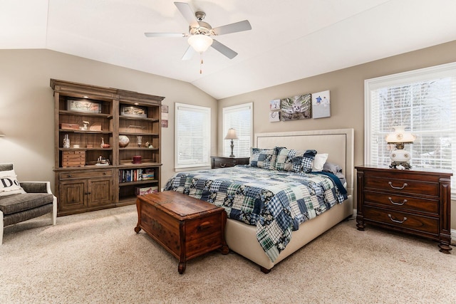 bedroom with multiple windows, light carpet, ceiling fan, and vaulted ceiling