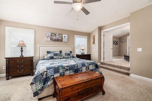 bedroom with vaulted ceiling, light colored carpet, and ceiling fan