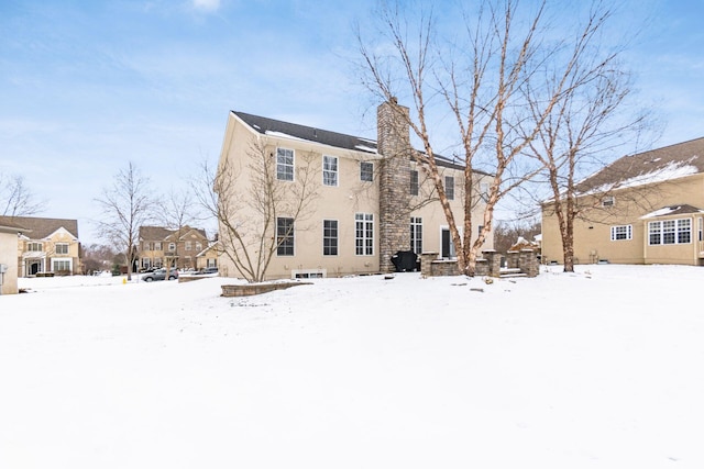 view of snow covered rear of property