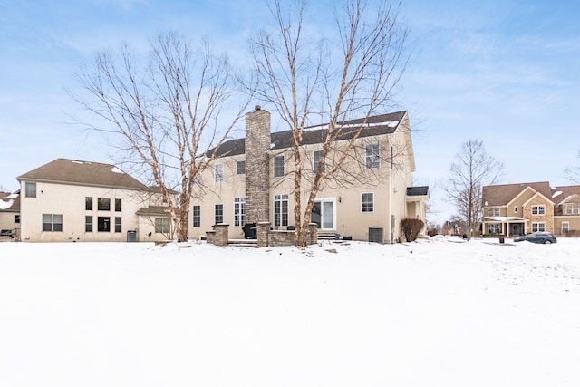 snow covered house with cooling unit