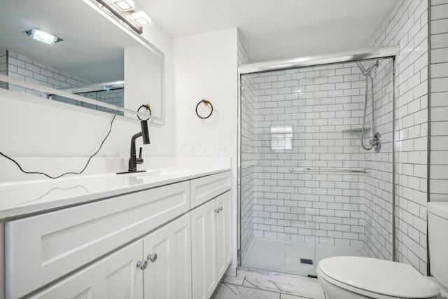 bathroom with vanity, toilet, and a shower with shower door