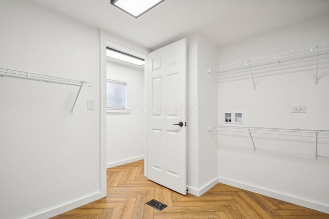 spacious closet featuring light parquet floors