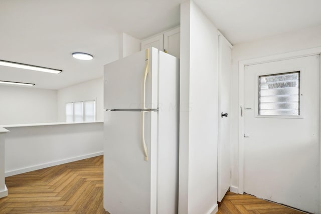 kitchen featuring light parquet flooring and white fridge