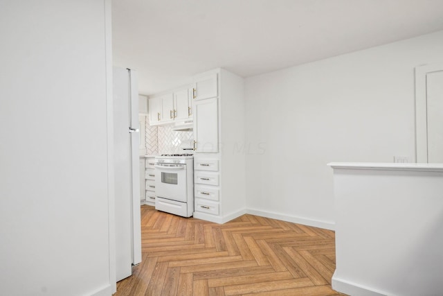 kitchen with white cabinets, tasteful backsplash, white stove, and light parquet floors