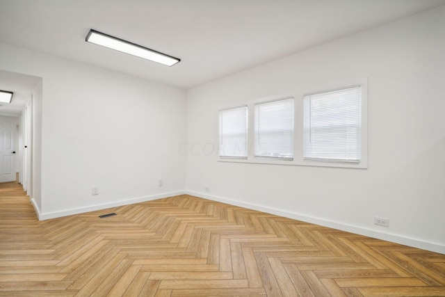 empty room with light parquet flooring