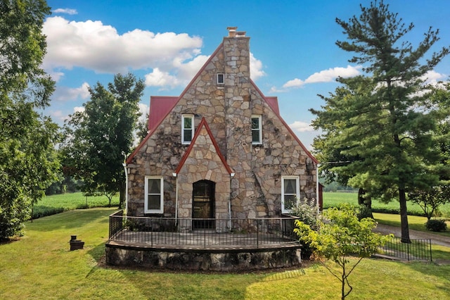 rear view of property with a lawn