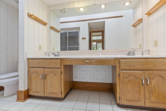 bathroom with tile patterned floors, vanity, and toilet