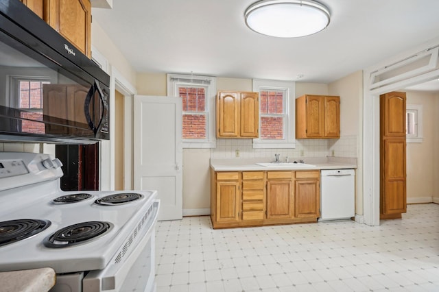 kitchen with tasteful backsplash, sink, and white appliances