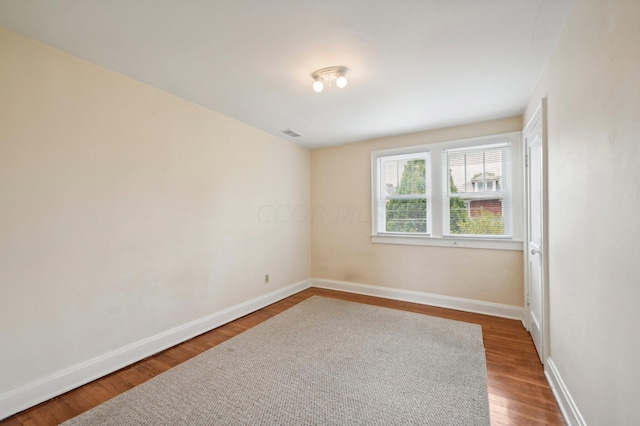 spare room featuring wood-type flooring