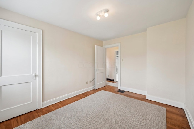 empty room with hardwood / wood-style floors