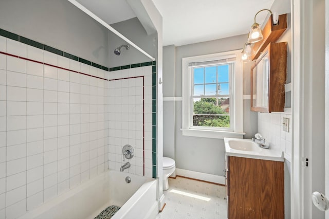 full bathroom featuring vanity, toilet, and tiled shower / bath