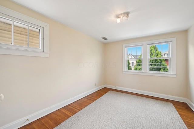 empty room with hardwood / wood-style flooring