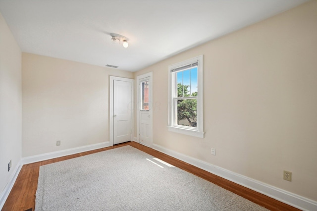 unfurnished room featuring hardwood / wood-style floors