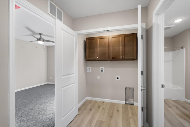 clothes washing area featuring electric dryer hookup, cabinets, light hardwood / wood-style flooring, washer hookup, and ceiling fan