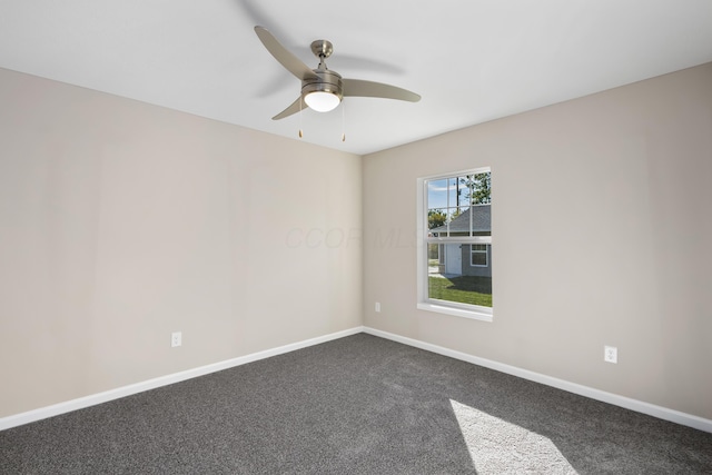 unfurnished room with ceiling fan and carpet