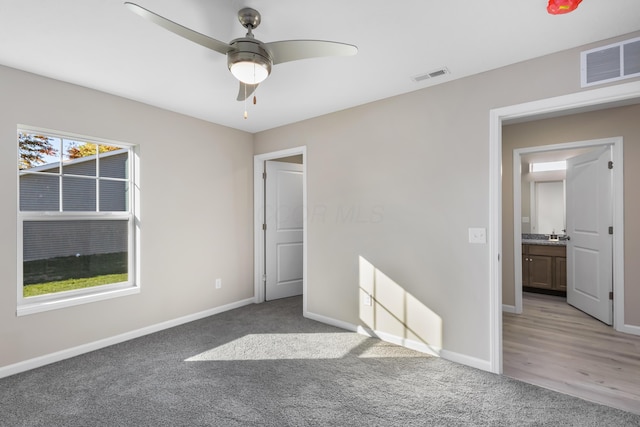 unfurnished bedroom with carpet floors and ceiling fan