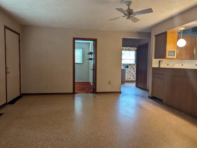 interior space featuring hanging light fixtures and ceiling fan