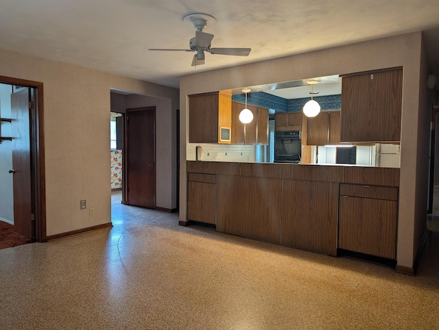 kitchen featuring pendant lighting, black oven, and ceiling fan