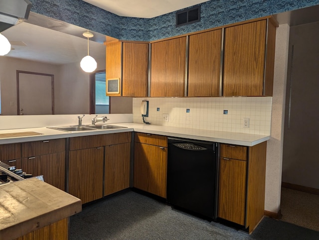 kitchen featuring backsplash, decorative light fixtures, sink, and black dishwasher