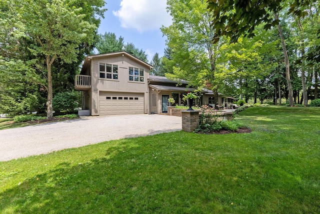 view of front of property featuring a front yard and a garage