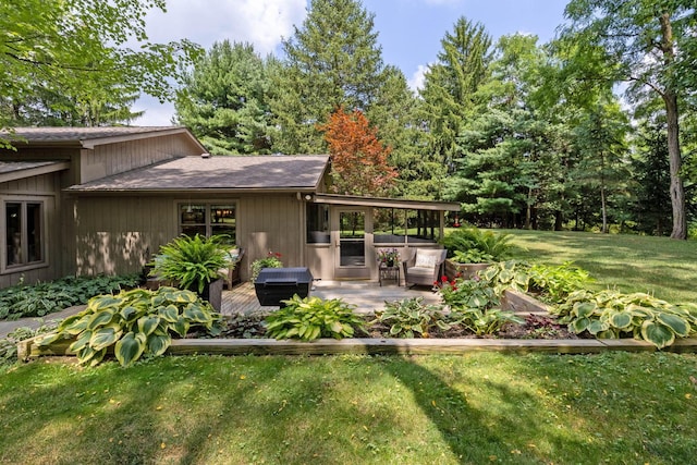 view of yard featuring a patio area and a wooden deck