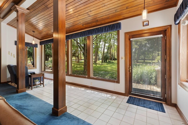 entryway featuring wooden ceiling, light tile patterned floors, and vaulted ceiling