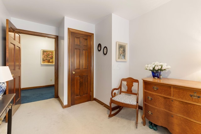 sitting room featuring light colored carpet